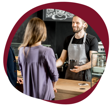 woman ordering at a coffee shop talking with barista